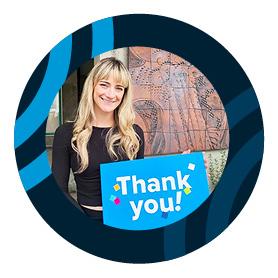 woman holding a thank-you sign.